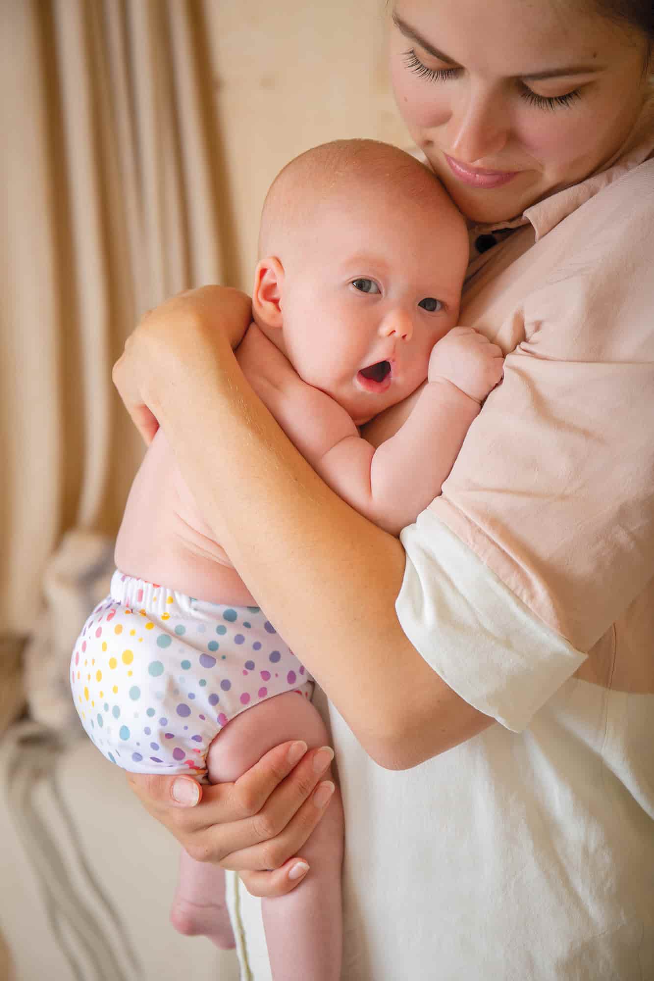 Parent holding baby considering sustainable new years resolutions