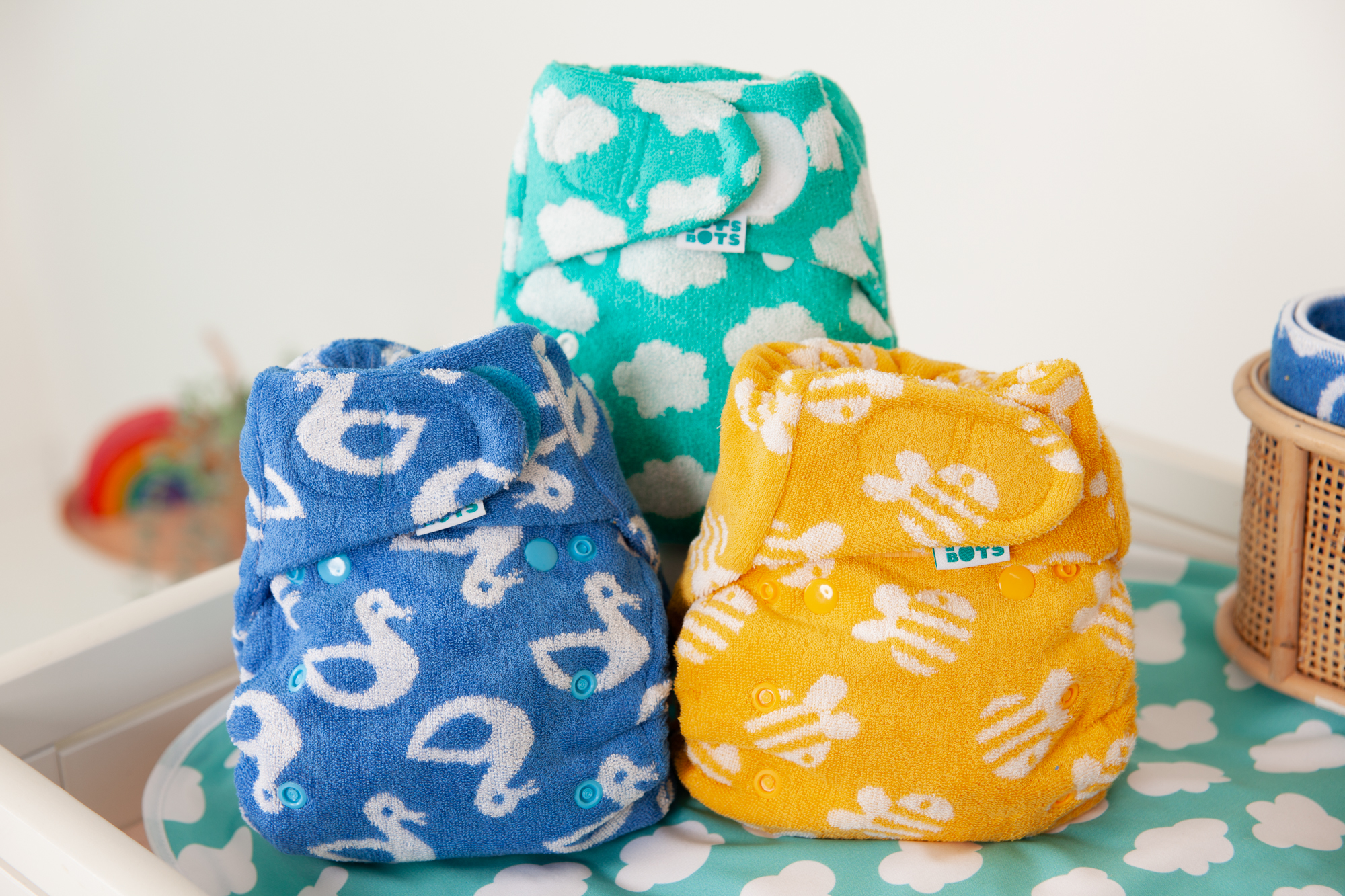Reusable cloth nappies stacked on a nappy changing table