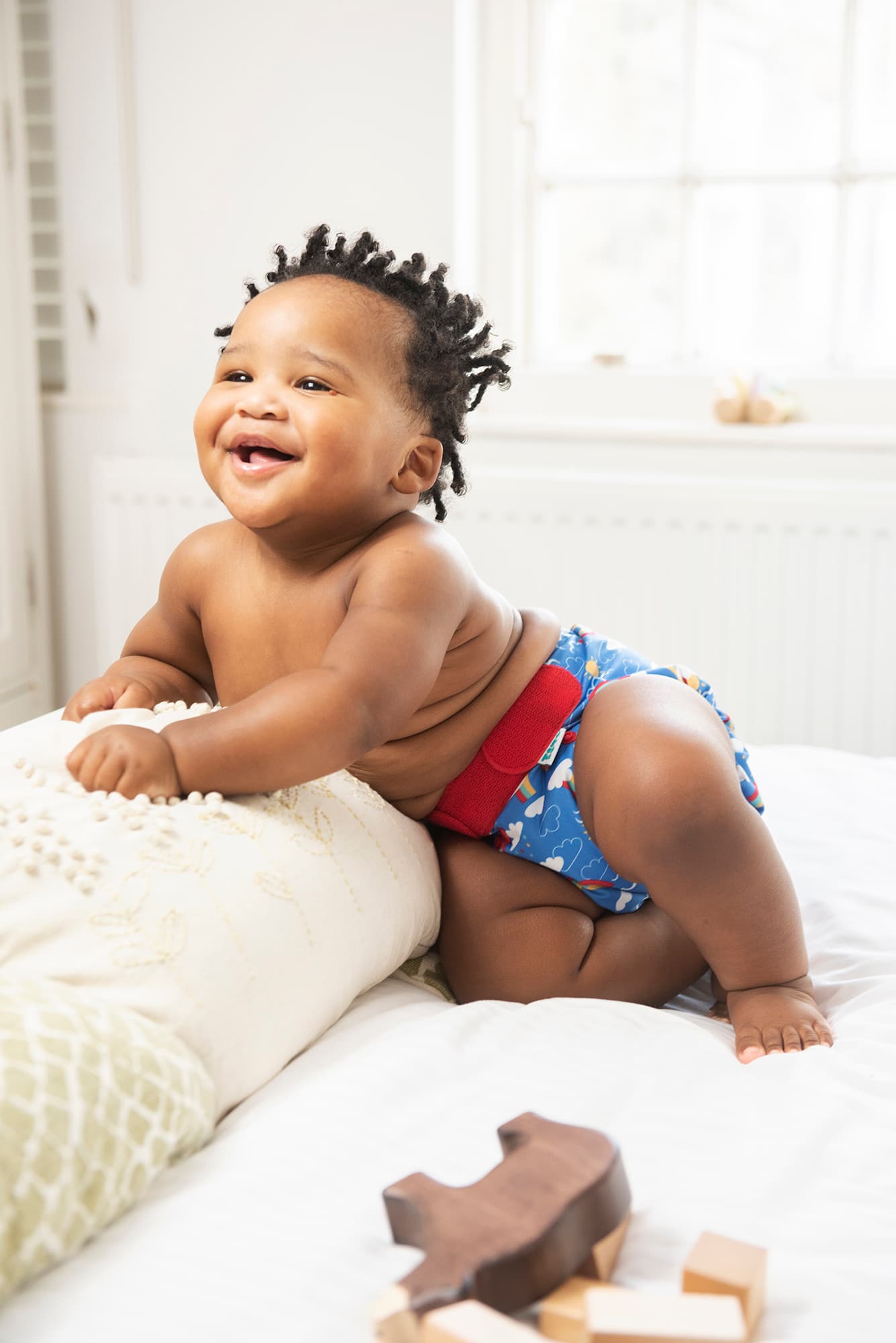 Baby wearing a reusable nappy smiling