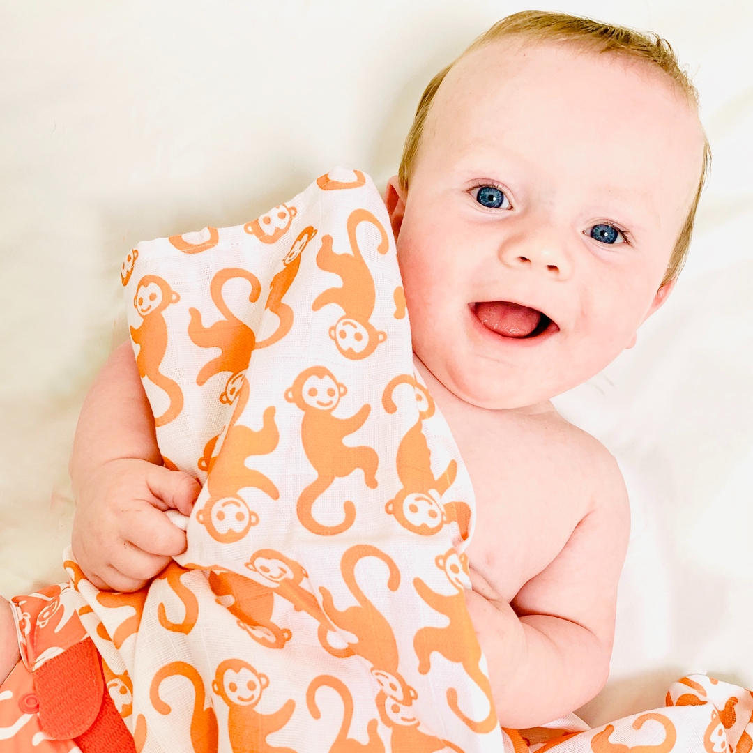 Little one holding a magnificent TotsBots Muslin